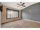 Bright bedroom with ceiling fan, large window, and neutral walls at 5648 Ancient Agora St, North Las Vegas, NV 89031