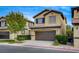 Two-story house with brown garage door, next to similar houses at 5648 Ancient Agora St, North Las Vegas, NV 89031