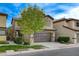 Two-story house with brown garage door and landscaping at 5648 Ancient Agora St, North Las Vegas, NV 89031