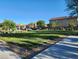 Large grassy park area with a paved walkway and mature trees at 6329 Supernova Hill St, North Las Vegas, NV 89031