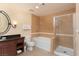 Bathroom with shower, bathtub, and dark vanity at 30 Strada Di Villaggio # 250, Henderson, NV 89011