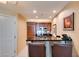 Modern condo kitchen with wood cabinets and breakfast bar at 145 E Harmon Ave # 1908, Las Vegas, NV 89109