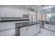 Modern kitchen with white shaker cabinets, a large island, and stainless steel appliances at 2951 Aruba Ct, Las Vegas, NV 89121