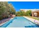 Long rectangular pool, waterfall feature, and lush landscaping at 2951 Aruba Ct, Las Vegas, NV 89121