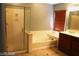 Bathroom with shower, bathtub, and double vanity at 1837 Ardilea St, Las Vegas, NV 89135