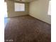 Spacious living room with carpeted floors and a sliding glass door at 5213 Castle Butte Ct, North Las Vegas, NV 89031