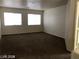 Spacious living room with neutral carpeting and large windows at 5213 Castle Butte Ct, North Las Vegas, NV 89031