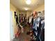 Large walk-in closet with hanging rods and shelving at 2409 W Gilmore Ave, North Las Vegas, NV 89032