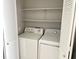 Convenient laundry room with washer, dryer, and shelving at 7950 W Flamingo Rd # 2028, Las Vegas, NV 89147