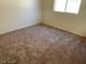 Simple carpeted bedroom with a window at 2506 Lady Elizabeth Ct, North Las Vegas, NV 89031