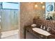 Spa-like bathroom with granite vanity, glass shower, and mosaic tile accents at 11587 Stardust Dr, Las Vegas, NV 89135