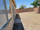 Large backyard with gravel and a paved walkway at 3012 Silver Canyon Ln, North Las Vegas, NV 89031