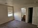 Bedroom with carpet, window, and access to bathroom at 7971 Duneville St, Las Vegas, NV 89139