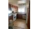 Kitchen with wood cabinets, stainless steel appliances and tile floor at 7200 Pirates Cove Rd # 2107, Las Vegas, NV 89145