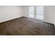 Bright bedroom with brown carpet and two windows at 3749 Carlyle Dr # 57, Las Vegas, NV 89115