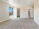 Spacious bedroom with large window, walk-in closet, and carpet at 9509 Swiss Stone Ct, Las Vegas, NV 89123