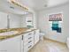 Bathroom with granite countertop, white cabinets, and tile floor at 9509 Swiss Stone Ct, Las Vegas, NV 89123