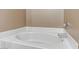 Bathroom with a large oval bathtub and tile surround at 5655 E Sahara Ave # 1052, Las Vegas, NV 89142