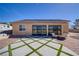 Backyard patio with diamond-patterned grass and seating area at 6440 Montclair St, Pahrump, NV 89061