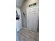 Small hallway with white door and wood-look floor at 3835 E Weld Ave, Pahrump, NV 89061