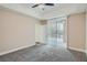 Spacious bedroom with carpet flooring and access to a balcony at 55 E Agate Ave # 202, Las Vegas, NV 89123