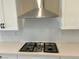 Stainless steel range hood and gas cooktop with white hexagon backsplash at 7148 Port Stephens St, North Las Vegas, NV 89084