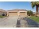 Two-car garage with a large driveway and desert landscaping at 1240 Country Club, Laughlin, NV 89029