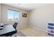 Bedroom with desk, chair, and ample natural light at 10472 Blue Rock St, Las Vegas, NV 89178