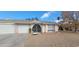 Single story home with a two-car garage and landscaped yard at 3214 Anacapa Way, Las Vegas, NV 89146