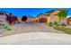 Single-story home with two-car garage and brick driveway at 593 Desert Bluebell Ct, Henderson, NV 89011