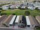 Aerial view of a row of homes with solar panels and carports, near a golf course at 880 Montecito Dr, Pahrump, NV 89048