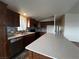 Modern kitchen with dark wood cabinets, quartz countertops, and stainless steel appliances at 880 Montecito Dr, Pahrump, NV 89048