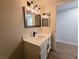 Modern bathroom with white vanity, updated fixtures, and stylish hexagon tile at 8301 Boseck Dr # 119, Las Vegas, NV 89145