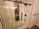 Clean bathroom with a tub and shower, glass enclosure, and modern tile at 8301 Boseck Dr # 119, Las Vegas, NV 89145