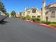 Townhouse community with a paved road and landscaping at 8301 Boseck Dr # 119, Las Vegas, NV 89145