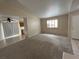 Spacious living room with neutral carpeting and tile flooring at 732 Goshawk St, Henderson, NV 89015