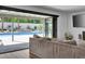 Living room with sliding glass doors opening to a refreshing pool area at 324 Park Way, Las Vegas, NV 89106