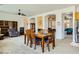 Dining room features a wooden table and chairs near a stone fireplace at 1505 Barrington Oaks St, North Las Vegas, NV 89084