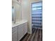 Clean bathroom with white vanity, mirror, and shower at 10021 Village Walk Ave, Las Vegas, NV 89149