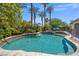 Inviting kidney shaped pool with spa and lush landscaping at 7364 Salvadora Pl, Las Vegas, NV 89113