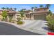 Tan two-story house with tile roof, two-car garage, and landscaped yard at 7364 Salvadora Pl, Las Vegas, NV 89113