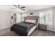 Main bedroom with tufted headboard, gray nightstands, and ensuite bathroom at 7345 Dazzle Point St, North Las Vegas, NV 89084