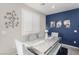 Elegant dining room with gray chairs and a blue accent wall at 7345 Dazzle Point St, North Las Vegas, NV 89084