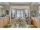 Luxurious bathroom with soaking tub, dual sinks, and large window at 2290 Casa Bella Ct, Las Vegas, NV 89117