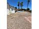 Large backyard with gravel, pool, and palm trees at 45 Logan Ct, Las Vegas, NV 89110