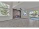 Spacious living room with a modern fireplace and large windows at 8908 Tumblewood Ave, Las Vegas, NV 89143