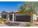 Single-story home with a two-car garage and landscaped front yard at 919 Jason Alexander Ave, North Las Vegas, NV 89031