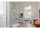 Bathroom with a walk-in shower, patterned floors, and access to bedroom at 919 Jason Alexander Ave, North Las Vegas, NV 89031