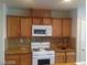 Kitchen with wood cabinets and granite countertops at 5308 La Quinta Hills St, North Las Vegas, NV 89081