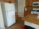 Kitchen with white appliances and wood cabinets at 5308 La Quinta Hills St, North Las Vegas, NV 89081